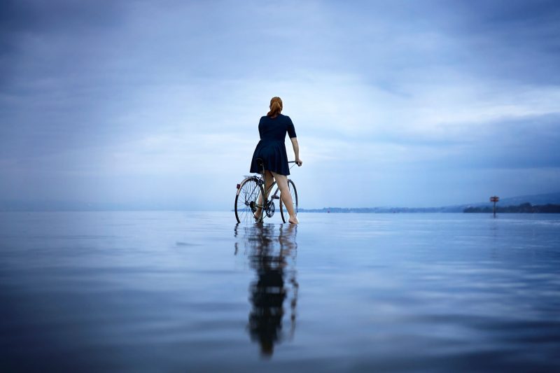 Delphine Millet You can go anywhere - Staged photography delicate sensitive surrealist lake bike possible impossible dream believe - Art conceptual photographer in Berlin